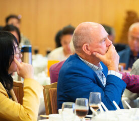 CAPRED activities manager Bill McDonald (right-) is listening carefully to the speech of the Cambodian representative.